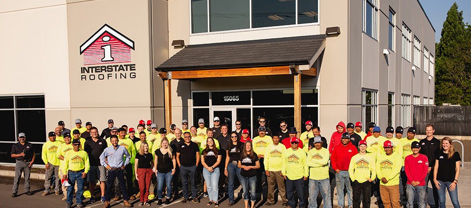 Interstate Roofing's team of roofing contractors standing outside headquarters in Portland, OR
