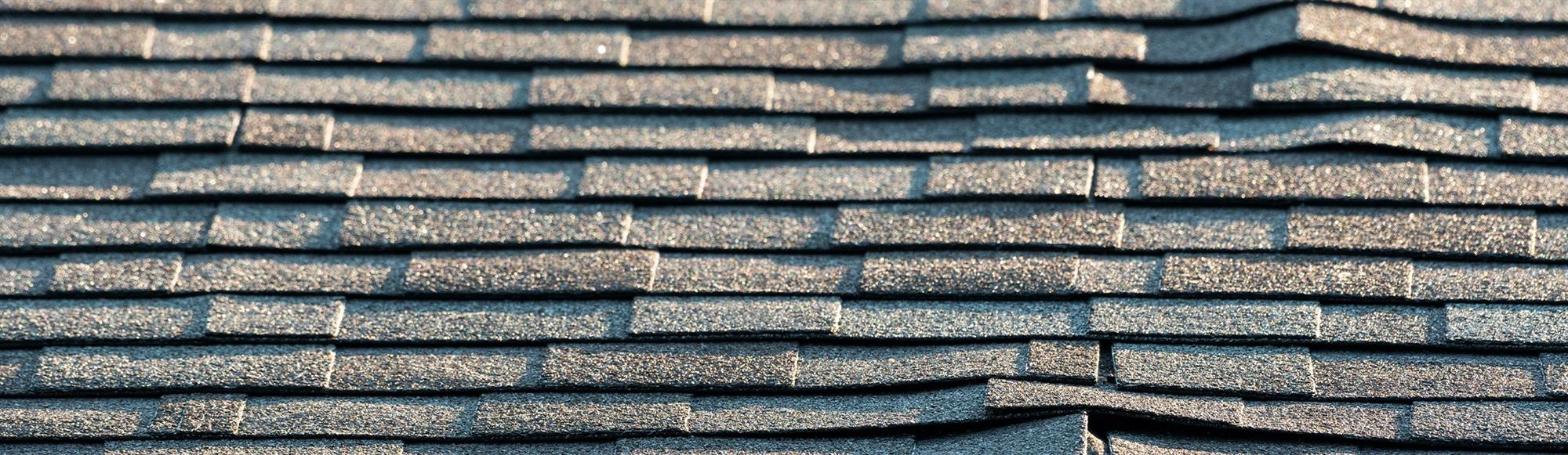 Damaged asphalt roof background