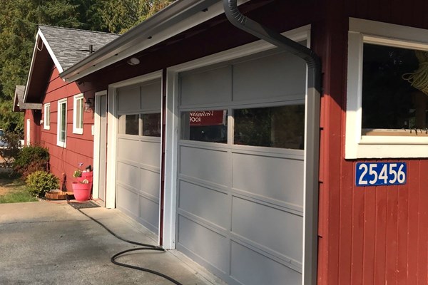 New gutters and downspouts installed on garage